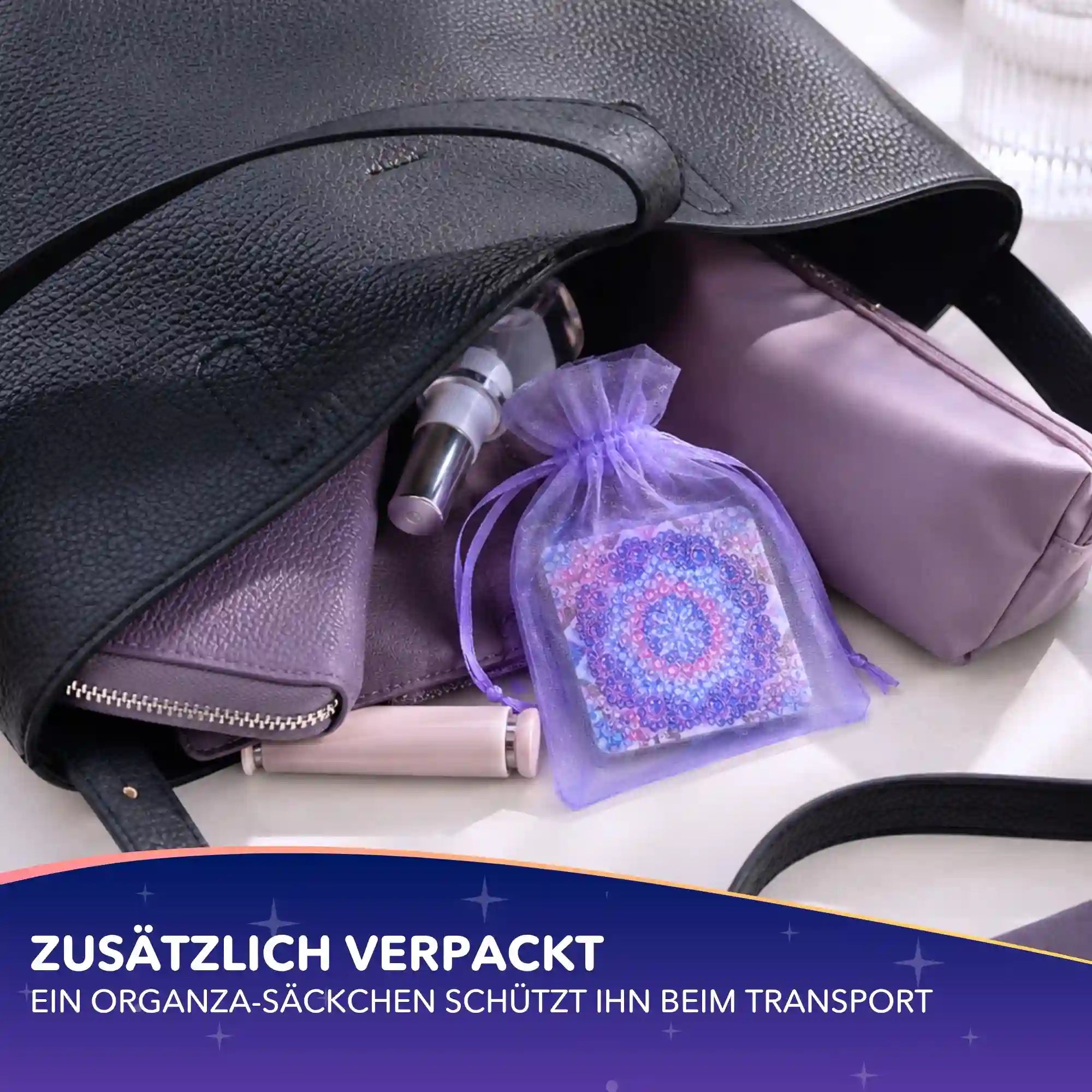 Diamond Painting Taschenspiegel mit Mandala-Motiv und runden Strasssteinen in einem lila Organza-Säckchen in einer Handtasche
